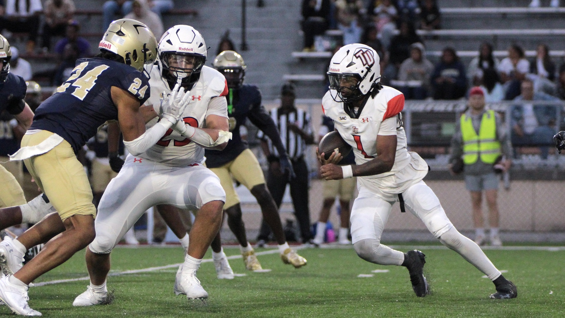Lex Dinwiddie blocks for fellow 100-yard rusher Buddy Taylor, part of a 468-yard performance on the ground by the Pioneers (photo by Kari Ham)