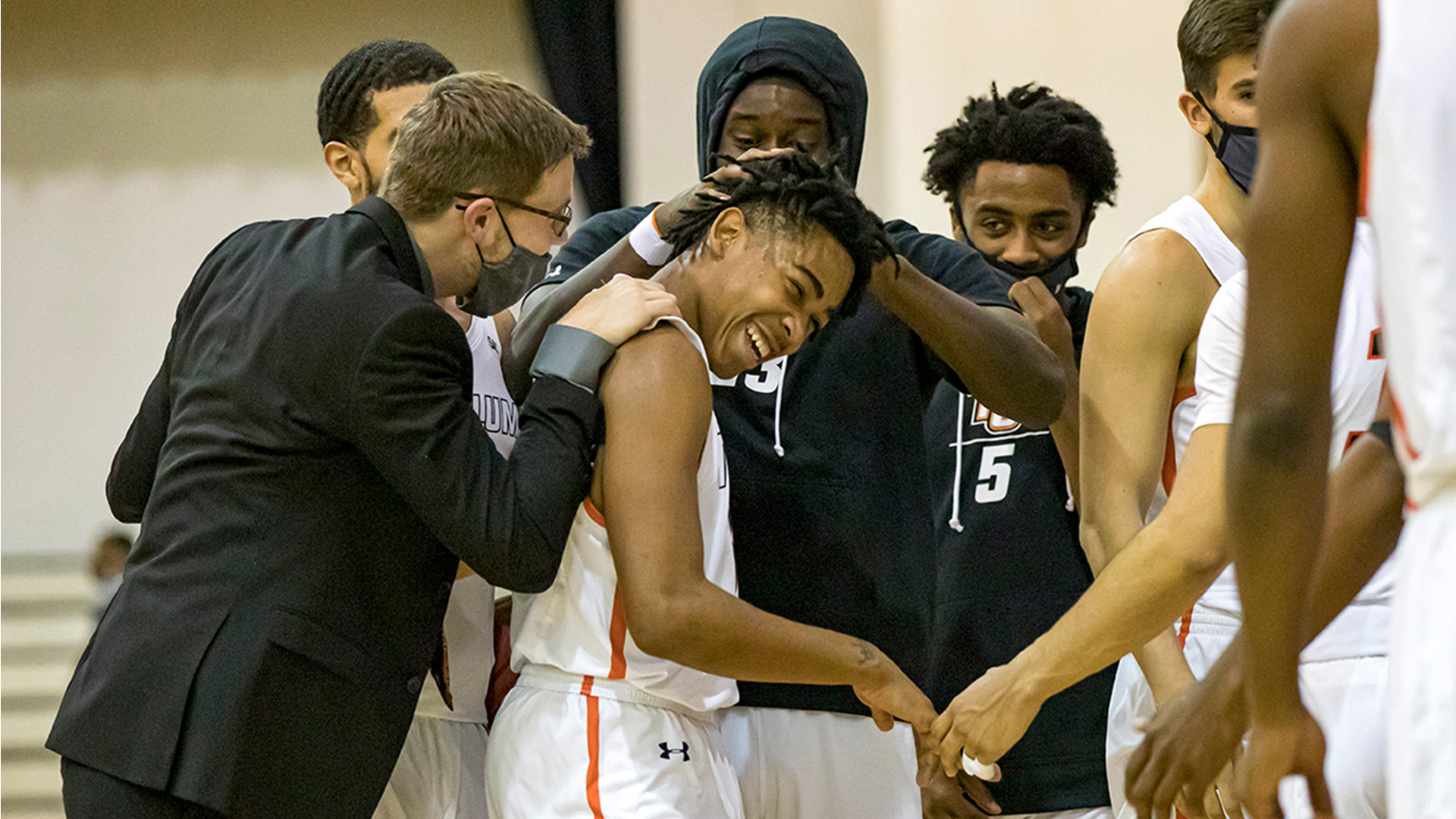 Freshman Kobe Funderburk is surrounded by his teammates as Tusculum defeated Wingate 87-75 (Photo by Chuck Williams)