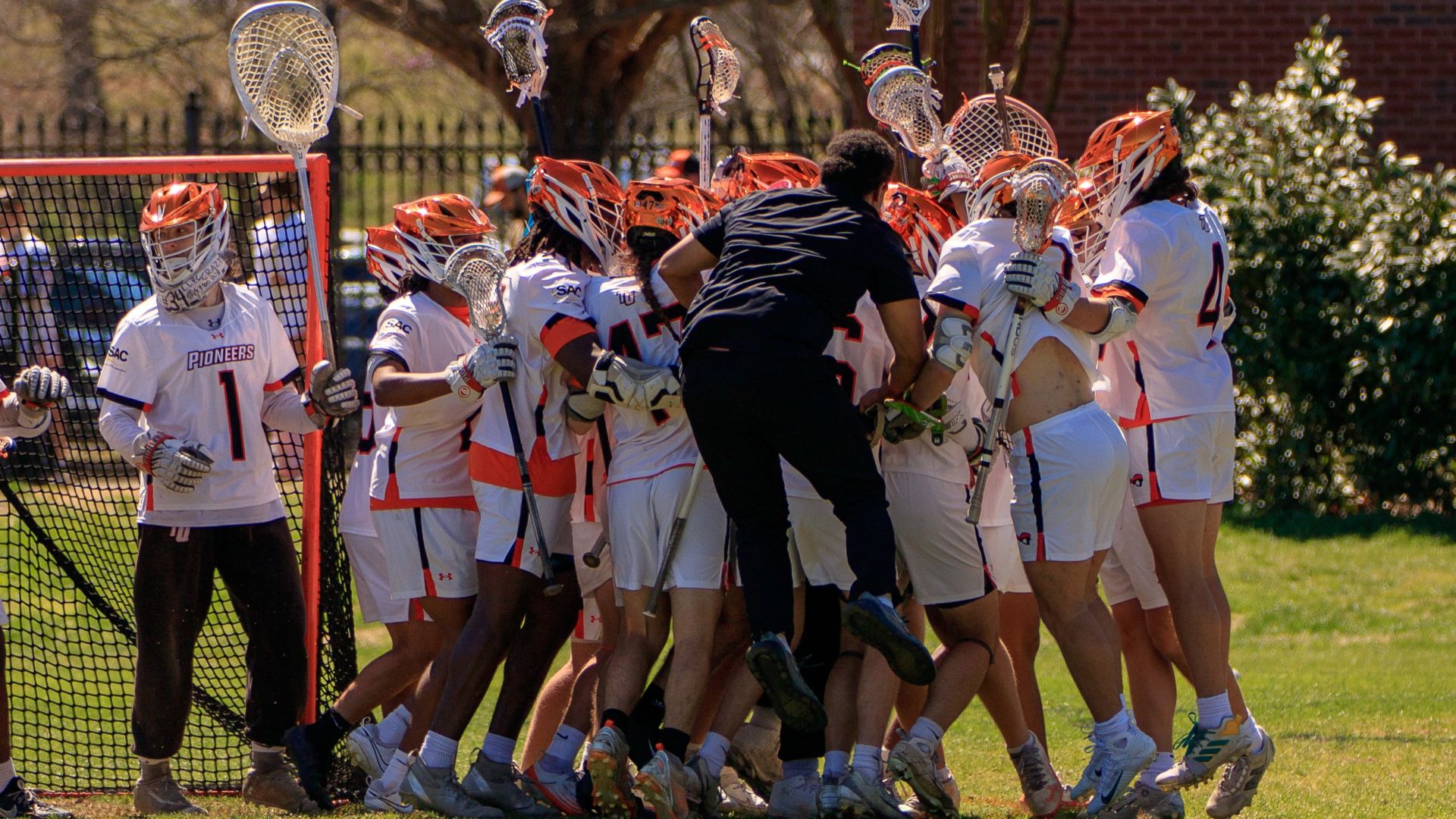 The Pioneers celebrate Saturday's 17-14 win over Coker (photo by Kari Ham)