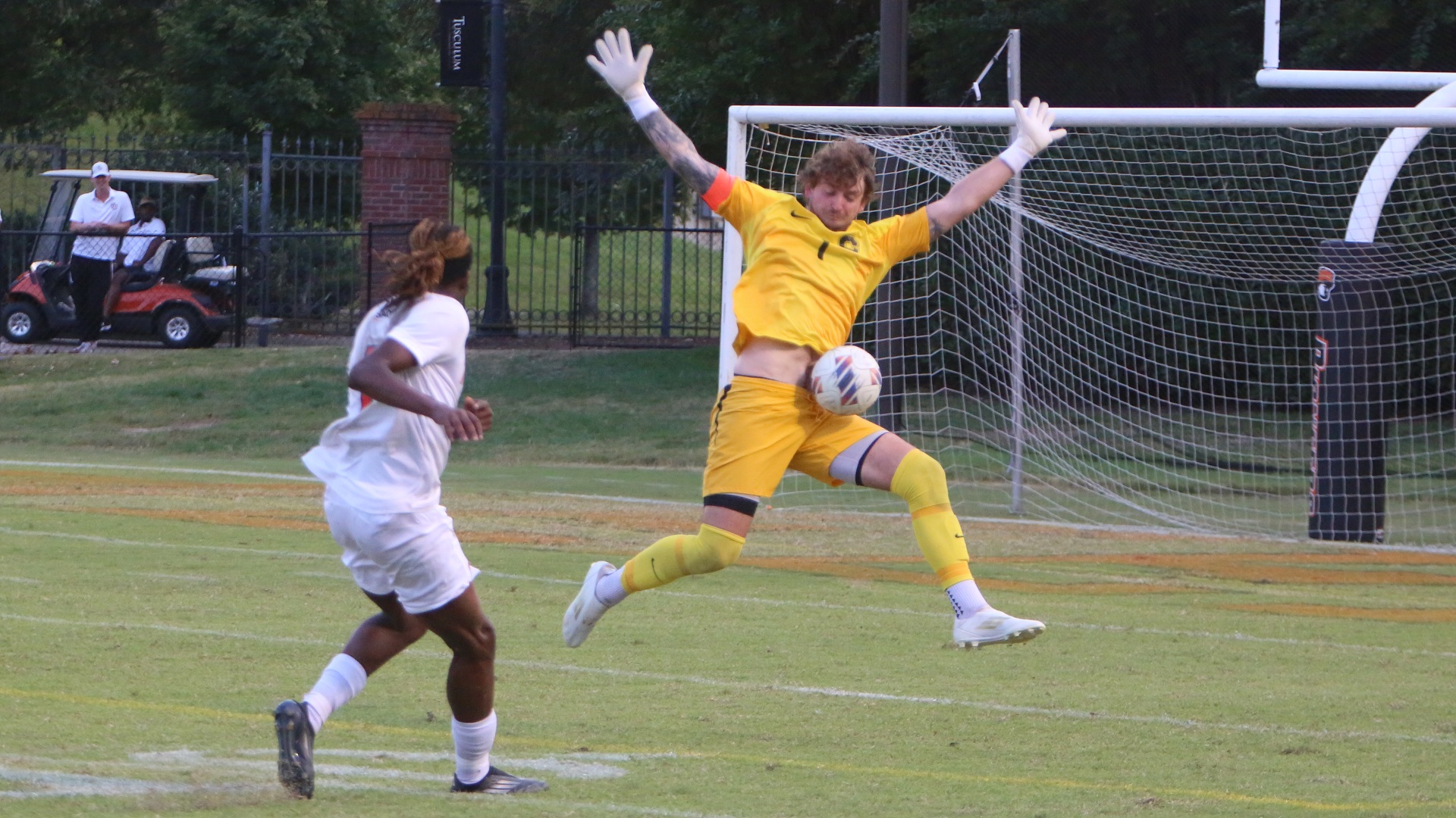 Catawba's Zak Stiffler deflects a shot from the Pioneers' Clarenns Sainrimat in the second half (photo by Dom Donnelly)