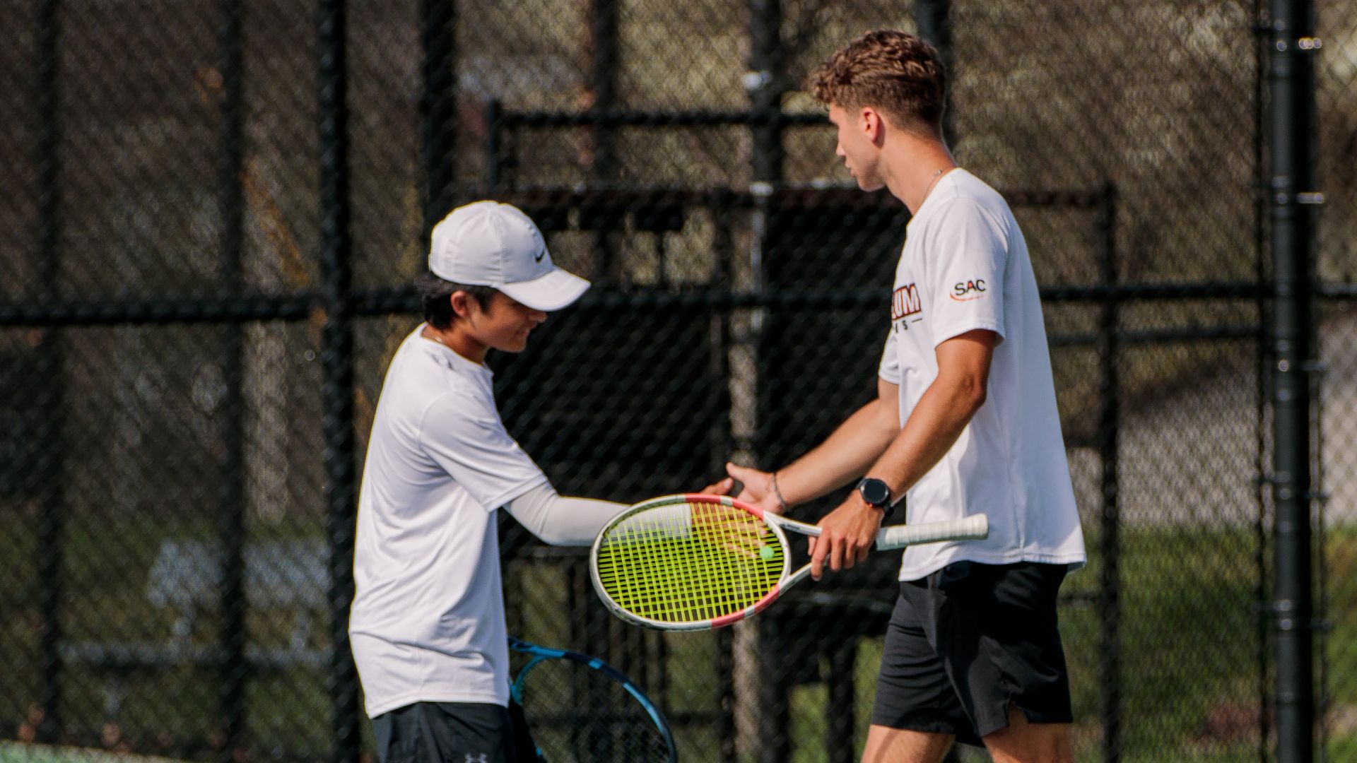 Shuzo Uemura (left) and Will Gee earned a win in doubles for the Pioneers against Mars Hill (photo by Kari Ham)
