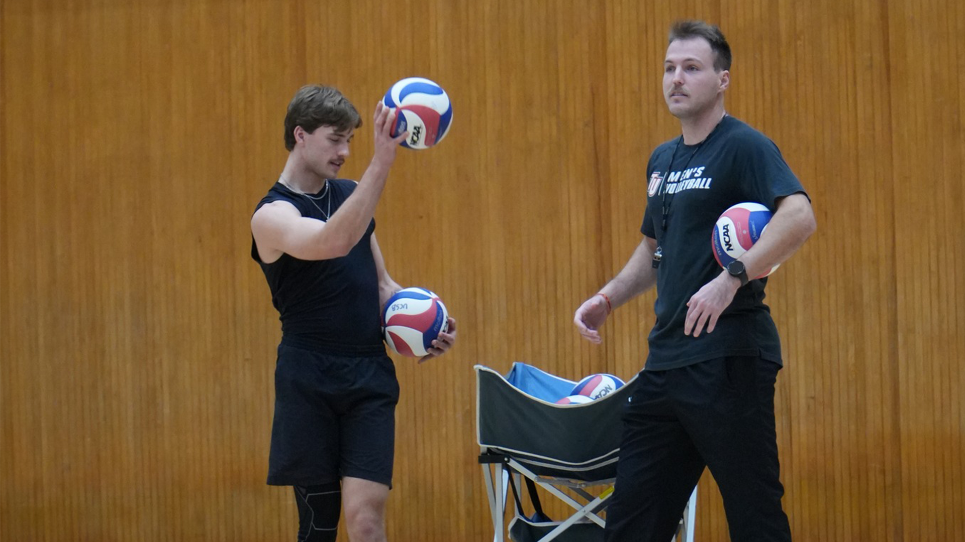 coach and player with volleyballs