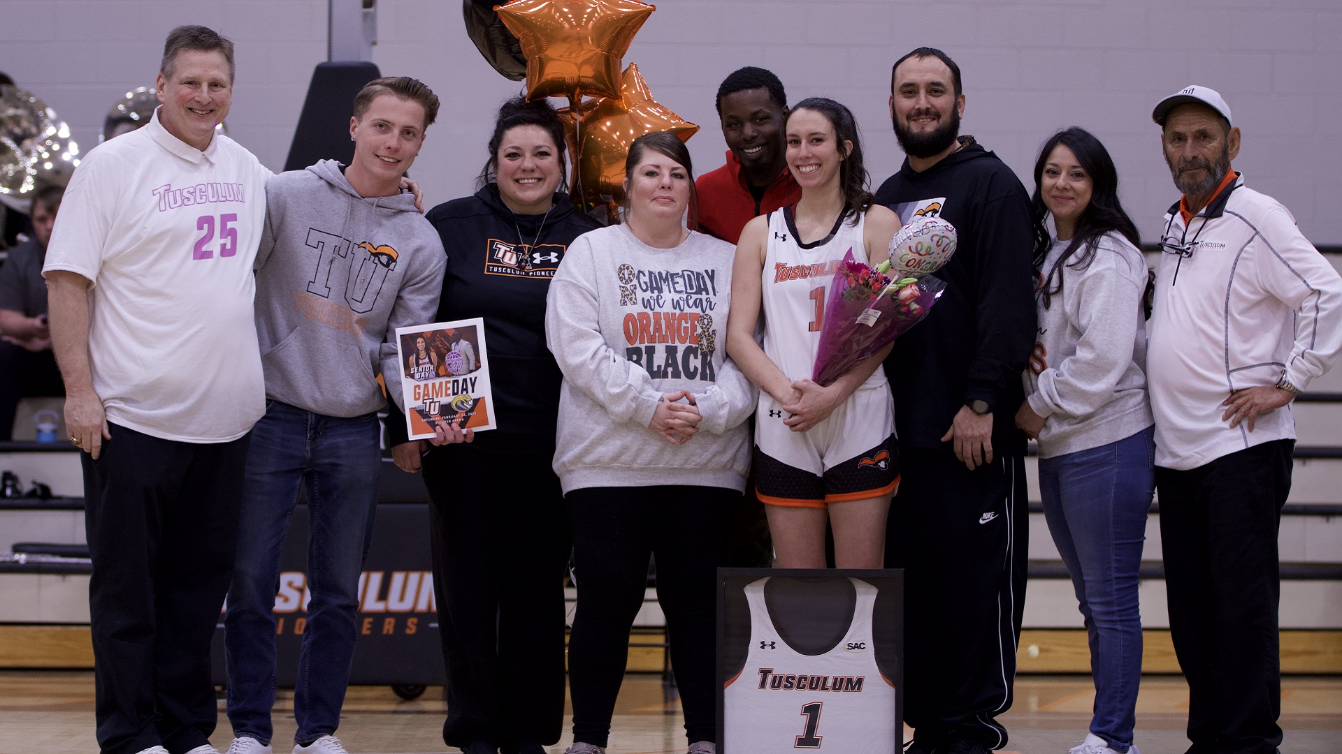 Faith Silva celebrates Senior Day with her family and head coach Roger Hodge (photo by Kari Ham)