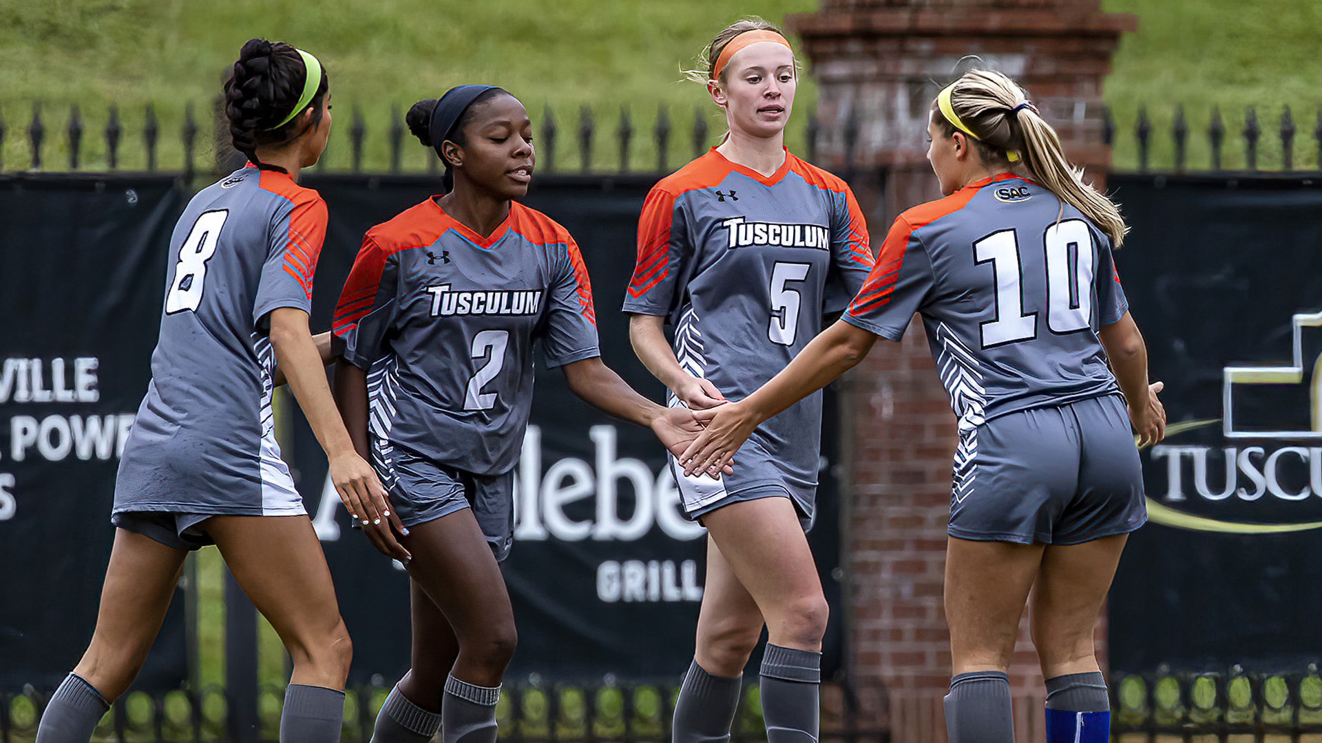 Taylor Youmans and Sydney Grant receive congratulations from Brianna Garcia and Bailey Bylotas after combining to give the Pioneers a 1-0 lead (photo by Chuck Williams)