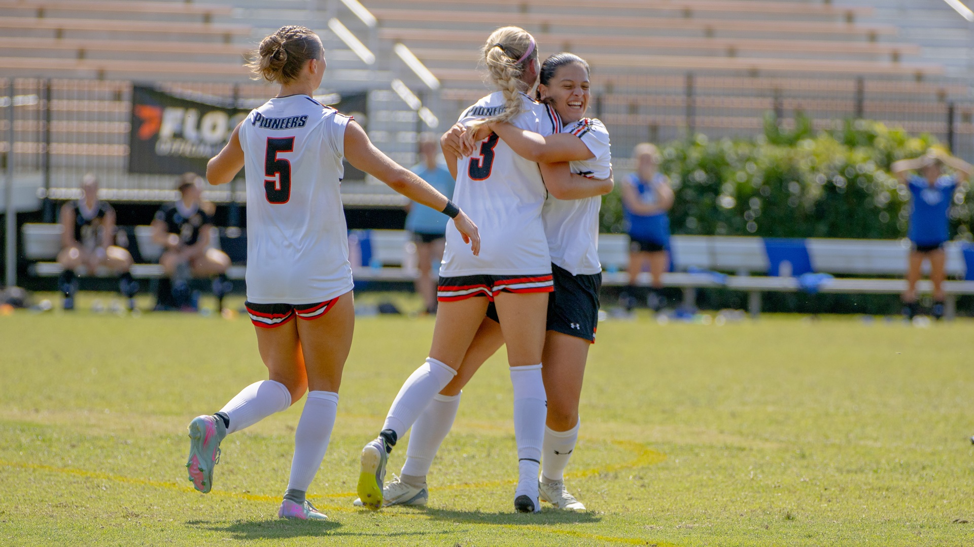 Wilma Axelsson hugs Carme Escamilla after the first of her two goals against Mars Hill (photo by Kari Ham)