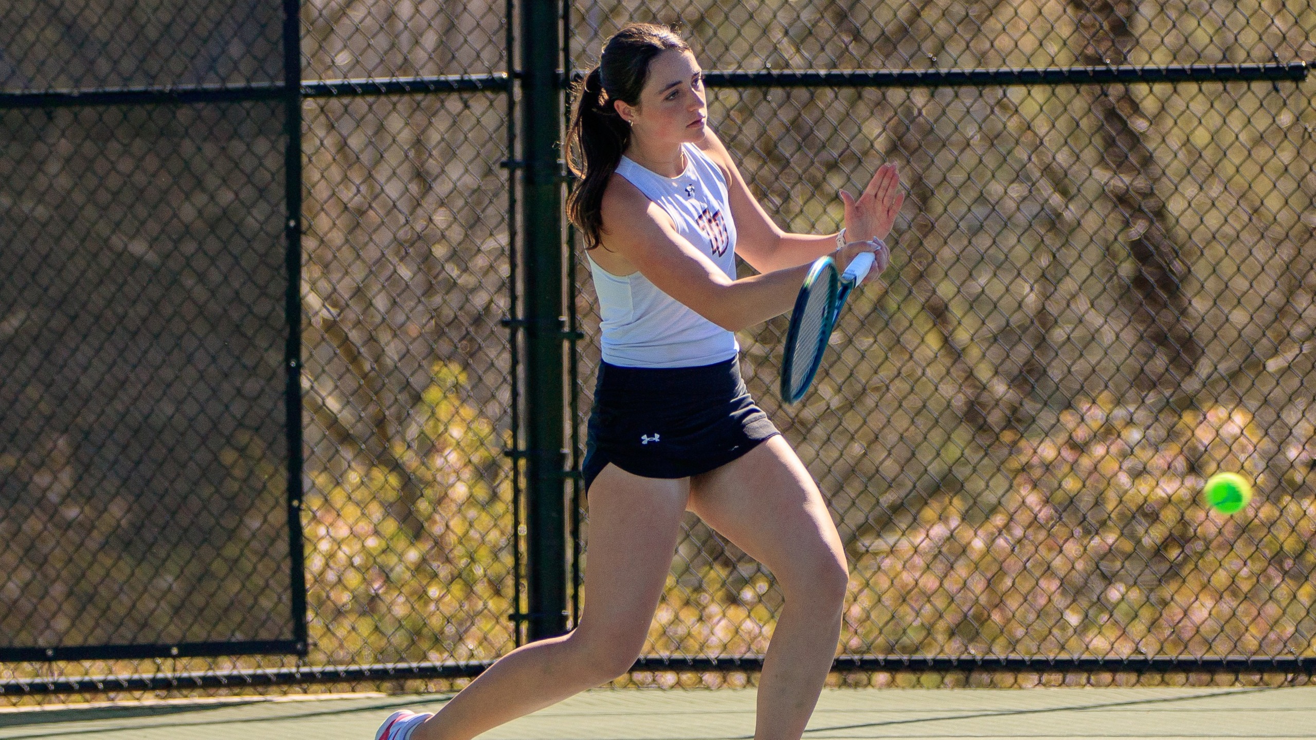 Sophia Amyes returns a shot against Lenoir-Rhyne (photo by Kari Ham)